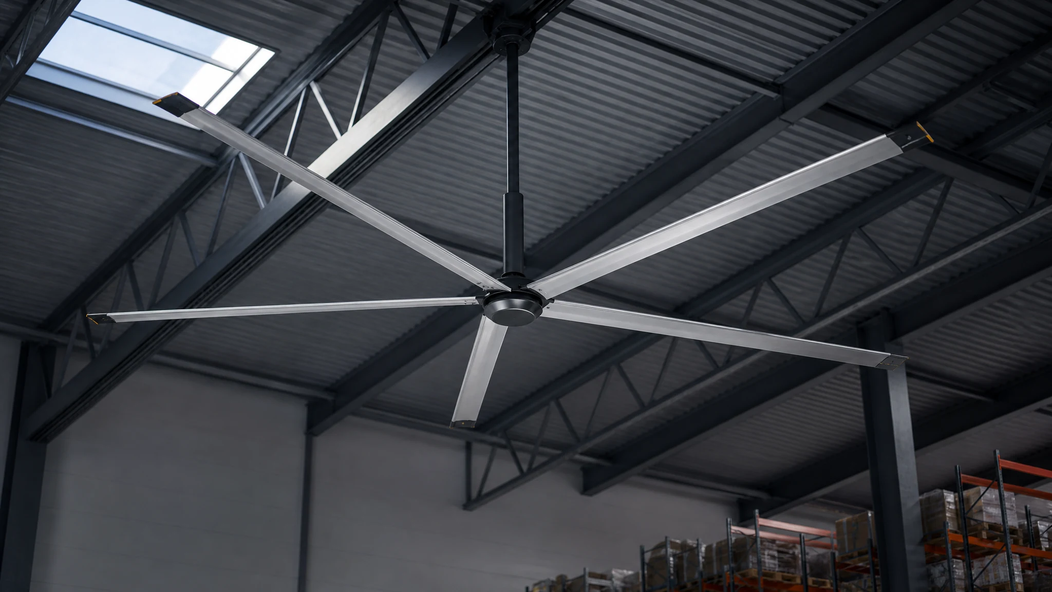 Six-blade HVLS ceiling fan integrated into warehouse roof structure