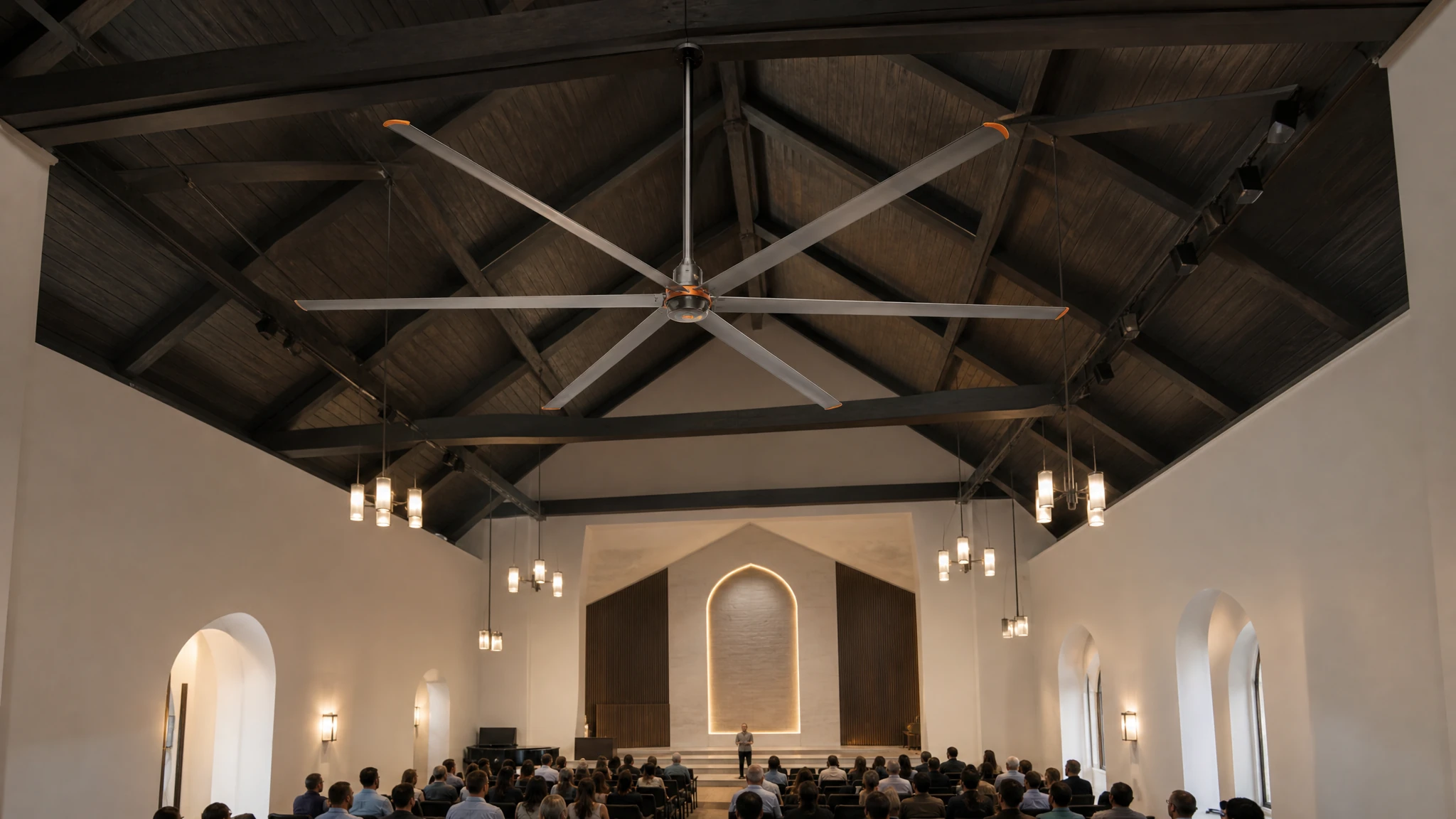 Six-blade HVLS fan integrated high above seating in a church or community hall